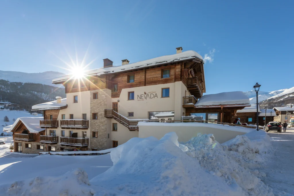 Hotel Bucaneve a Livigno immerso nella neve con sole invernale tra le Alpi